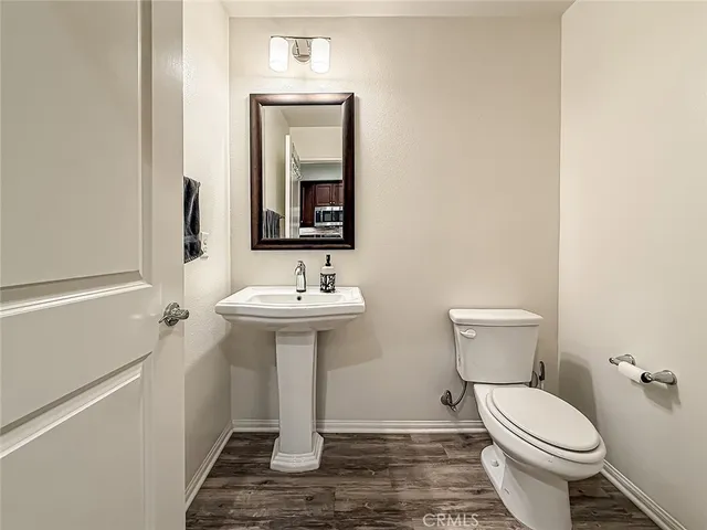 a bathroom with a sink toilet and mirror