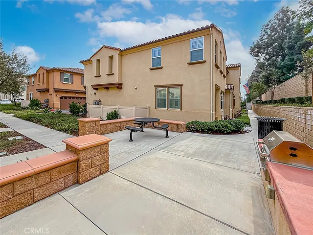 a building outdoor space with patio furniture and a fireplace