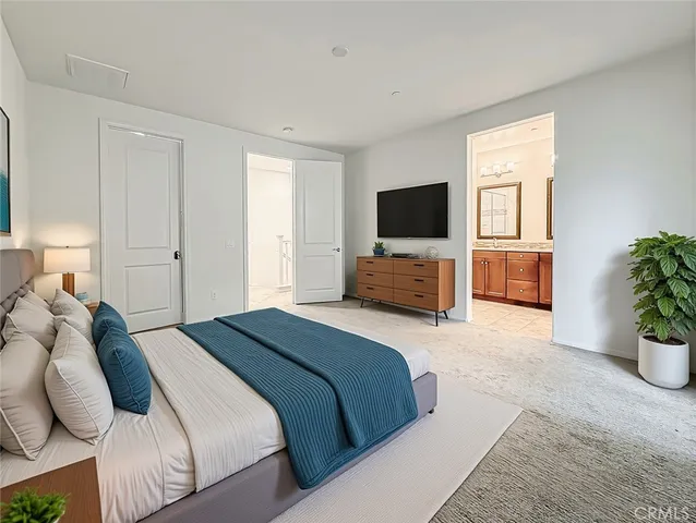 a bedroom with a bed and a flat screen television