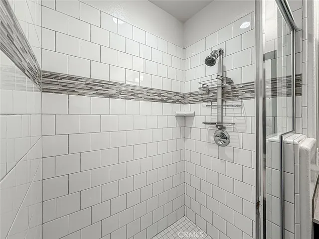 a bathroom with a granite countertop sink double and mirror
