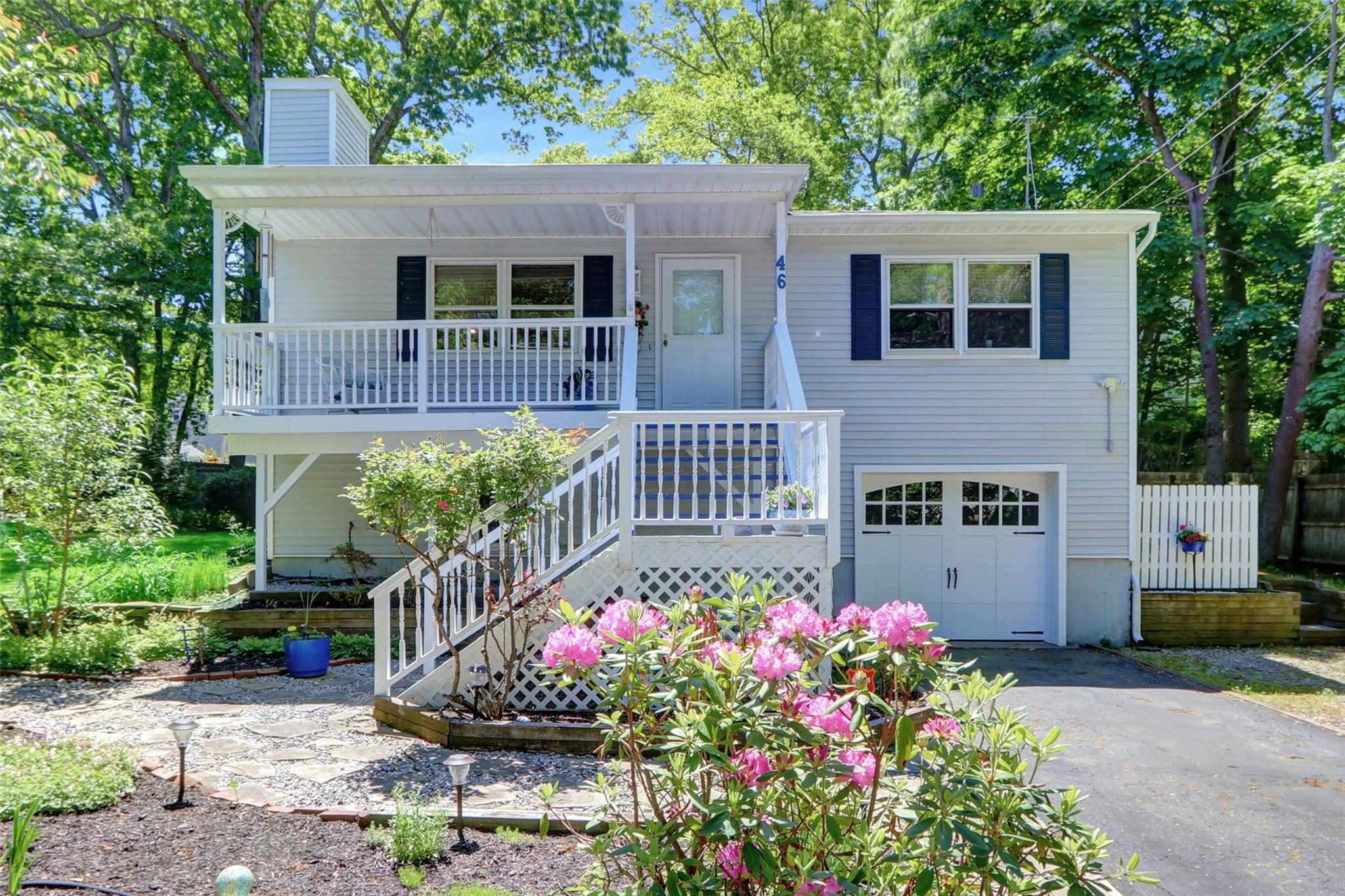 46 Narcissus Road Rocky Point, NY 11778 - Photo 1 of 1 View of front of home with asphalt driveway, a chimney, a porch, and a garage