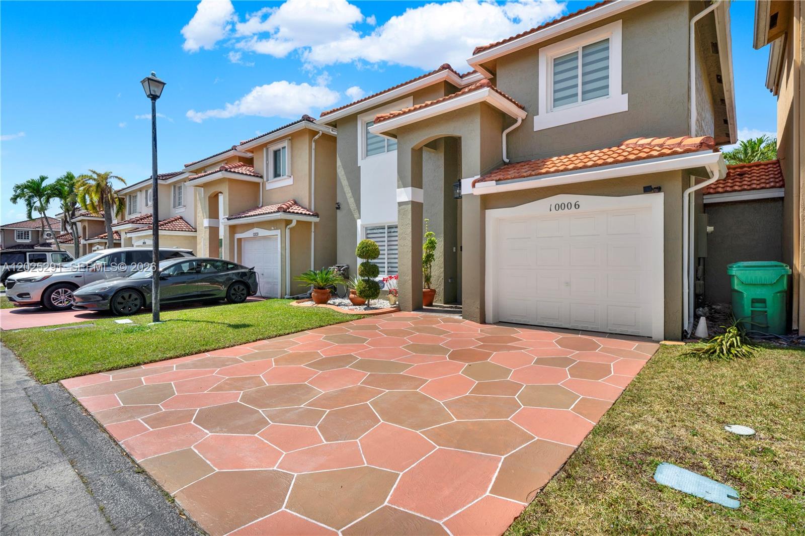 10006 Southwest 162nd Path Miami, FL 33196 - Photo 3 of 40 a front view of a house with a yard