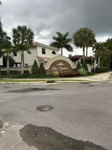 a view of a house with a yard and potted plants