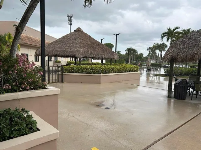 a view of a patio with dining table and chairs under an umbrella
