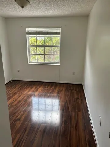a view of a room with wooden floor