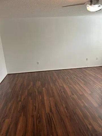an empty room with wooden floor