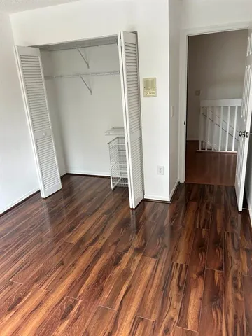 a view of wooden floor and windows in a room