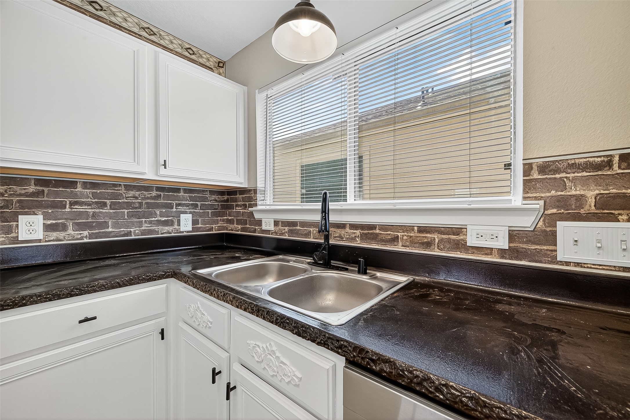 6343 Settlers Square Lane Katy, TX 77449 - Photo 23 of 41 a kitchen with granite countertop a sink and a white wooden cabinets