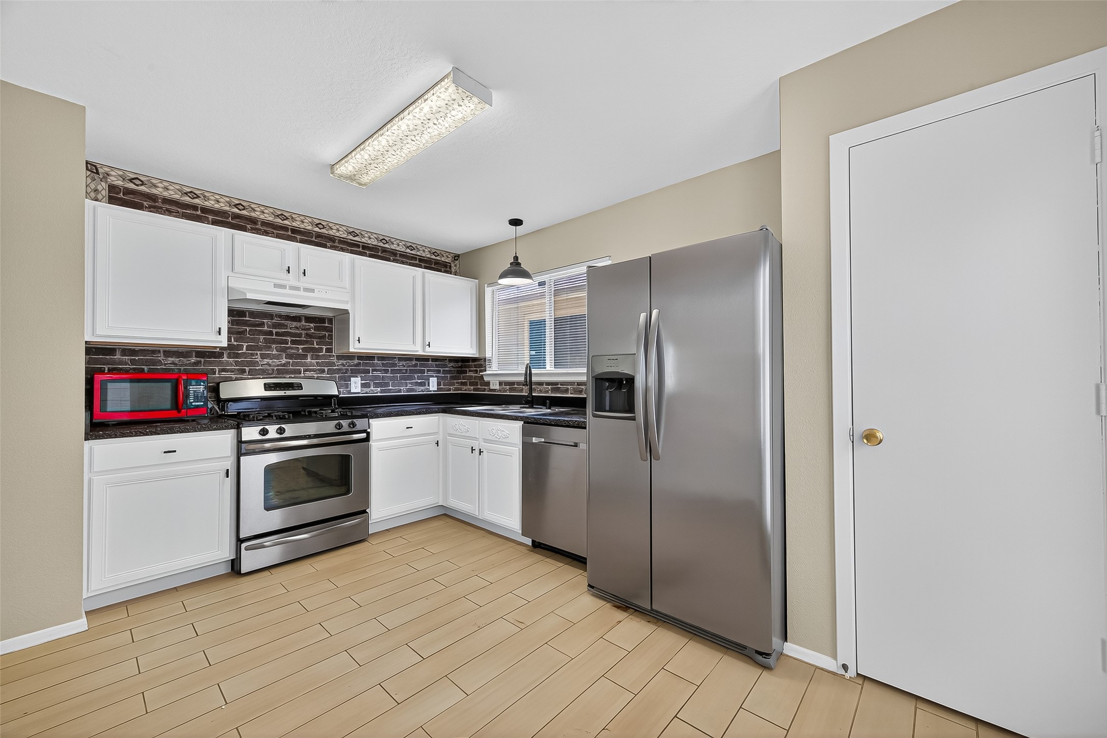 6343 Settlers Square Lane Katy, TX 77449 - Photo 24 of 41 a kitchen with stainless steel appliances granite countertop a refrigerator and a stove