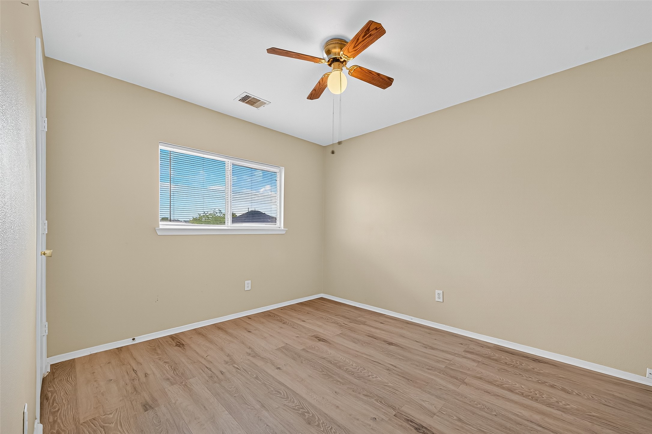 6343 Settlers Square Lane Katy, TX 77449 - Photo 35 of 41 an empty room with wooden floor and ceiling fan