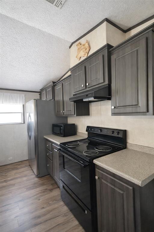 112 Rising Star Quitman, TX 75783 - Photo 11 of 39 a kitchen with stainless steel appliances granite countertop a stove a sink and a refrigerator