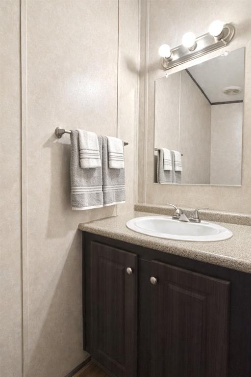 112 Rising Star Quitman, TX 75783 - Photo 15 of 39 a bathroom with a granite countertop sink and a mirror