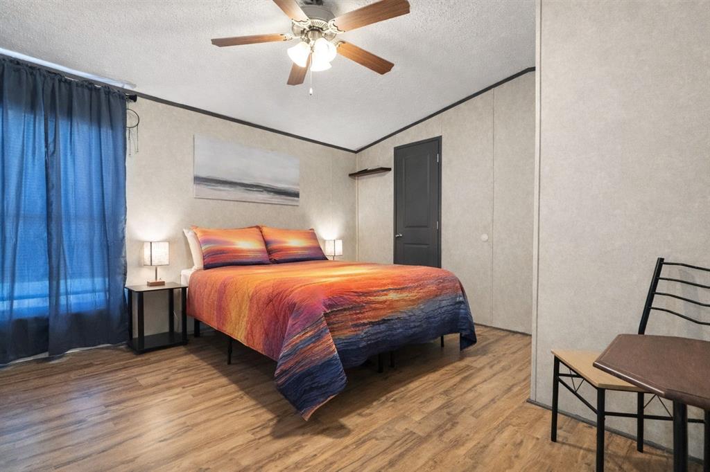 112 Rising Star Quitman, TX 75783 - Photo 16 of 39 a bedroom with a bed and a chandelier
