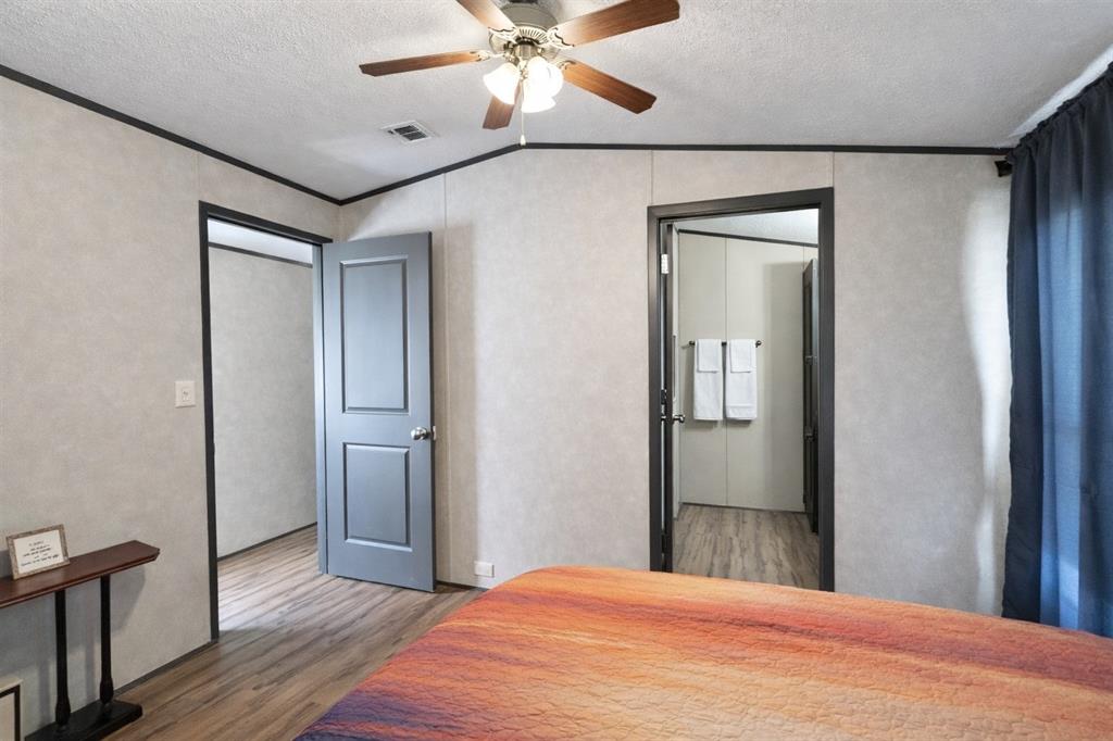 112 Rising Star Quitman, TX 75783 - Photo 17 of 39 a bedroom with a bed and a chandelier