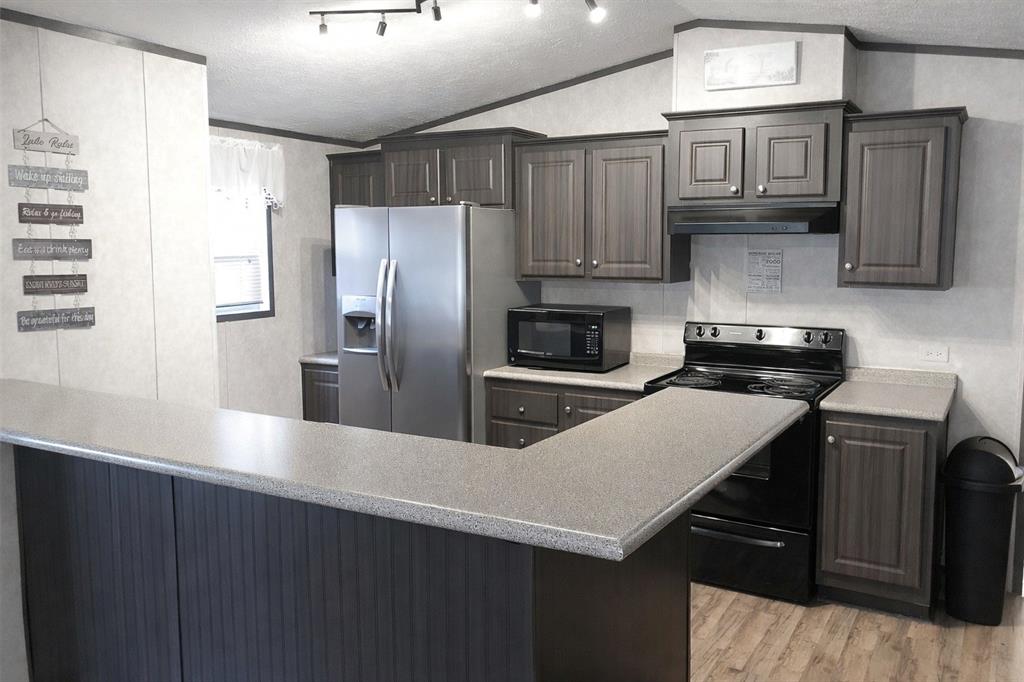 112 Rising Star Quitman, TX 75783 - Photo 9 of 39 a kitchen with cabinets and stainless steel appliances