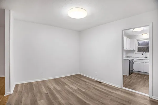a view of a room with wooden floor and a sink
