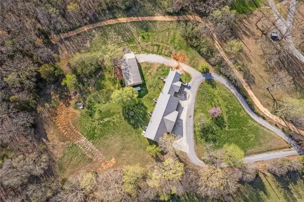 an aerial view of a house with a yard and lake view