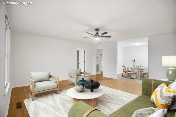 a living room with furniture and a wooden floor