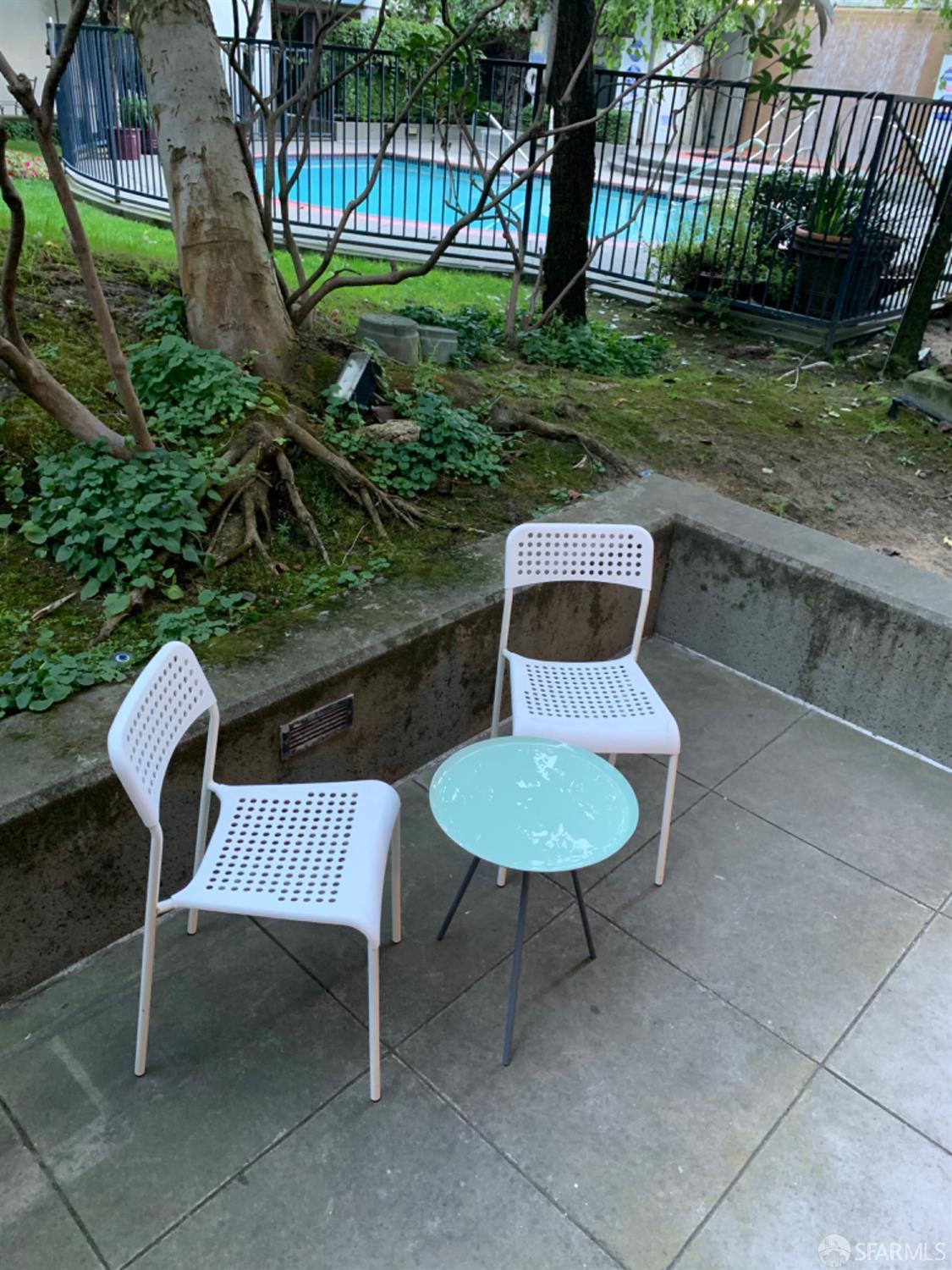 a view of a chair and table in backyard