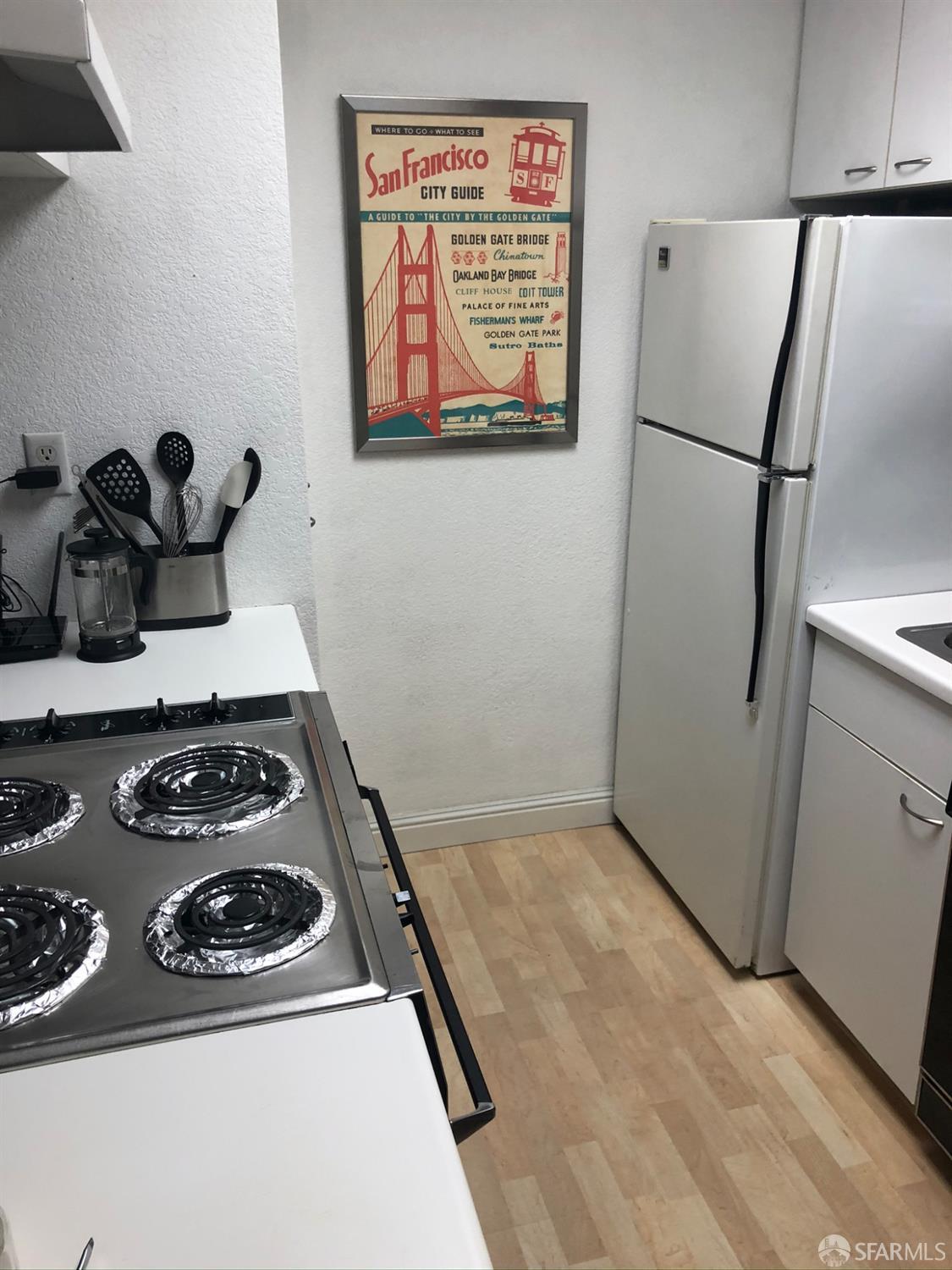 201 Harrison Street, Unit 129 San Francisco, CA 94105 - Photo 12 of 19 a stove top oven sitting inside of a kitchen