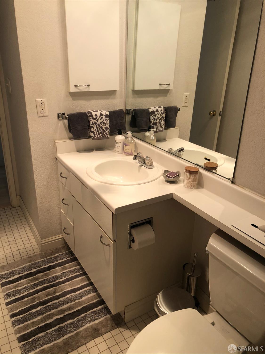 201 Harrison Street, Unit 129 San Francisco, CA 94105 - Photo 13 of 19 a bathroom with a sink and a mirror