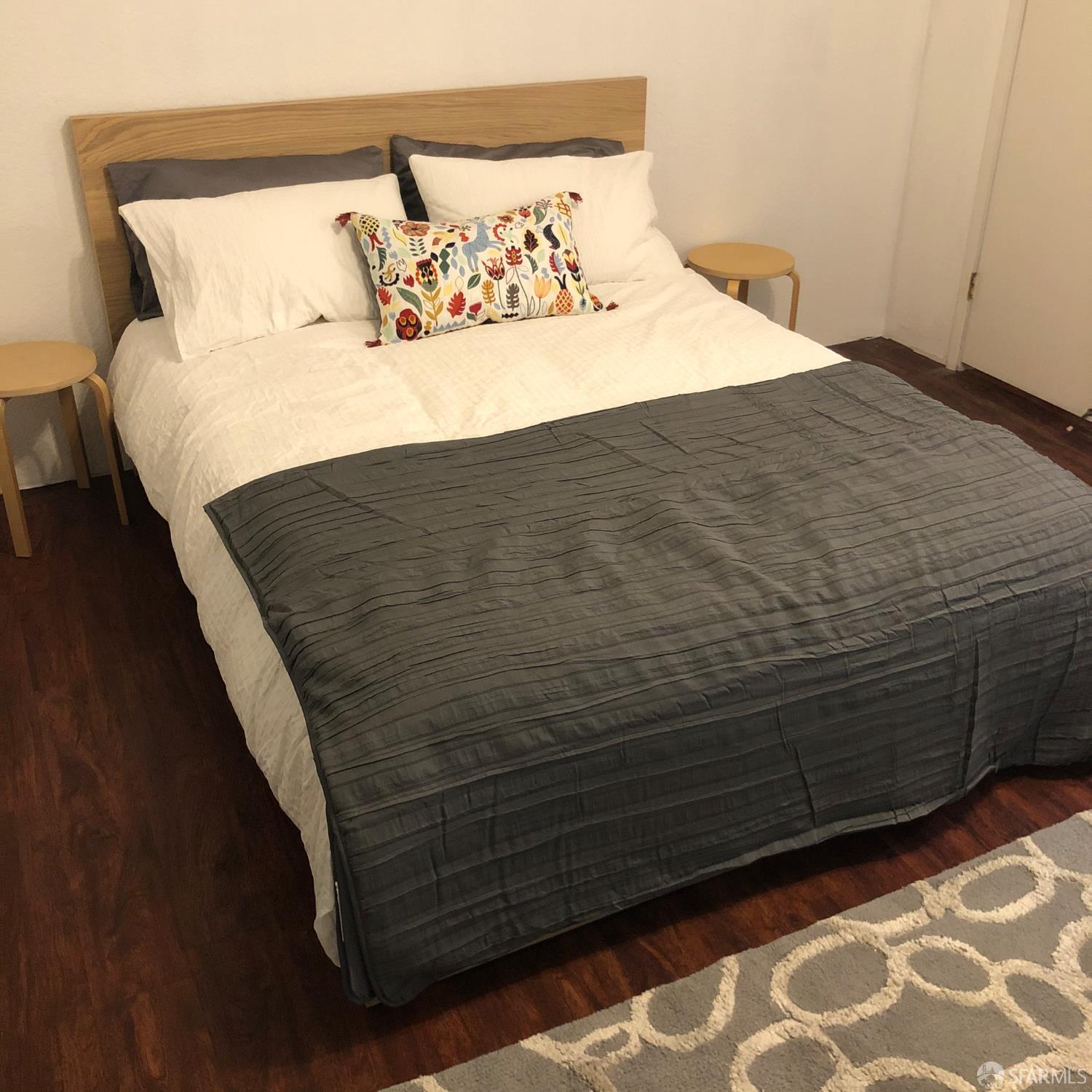 201 Harrison Street, Unit 129 San Francisco, CA 94105 - Photo 19 of 19 a bedroom with a bed and wooden floor