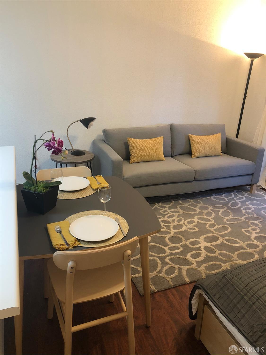 201 Harrison Street, Unit 129 San Francisco, CA 94105 - Photo 6 of 19 a living room with a couch and wooden floor