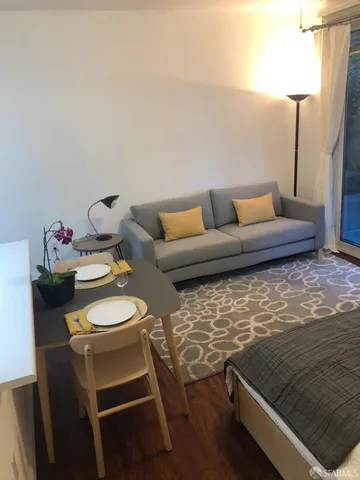 a balcony with table and chairs