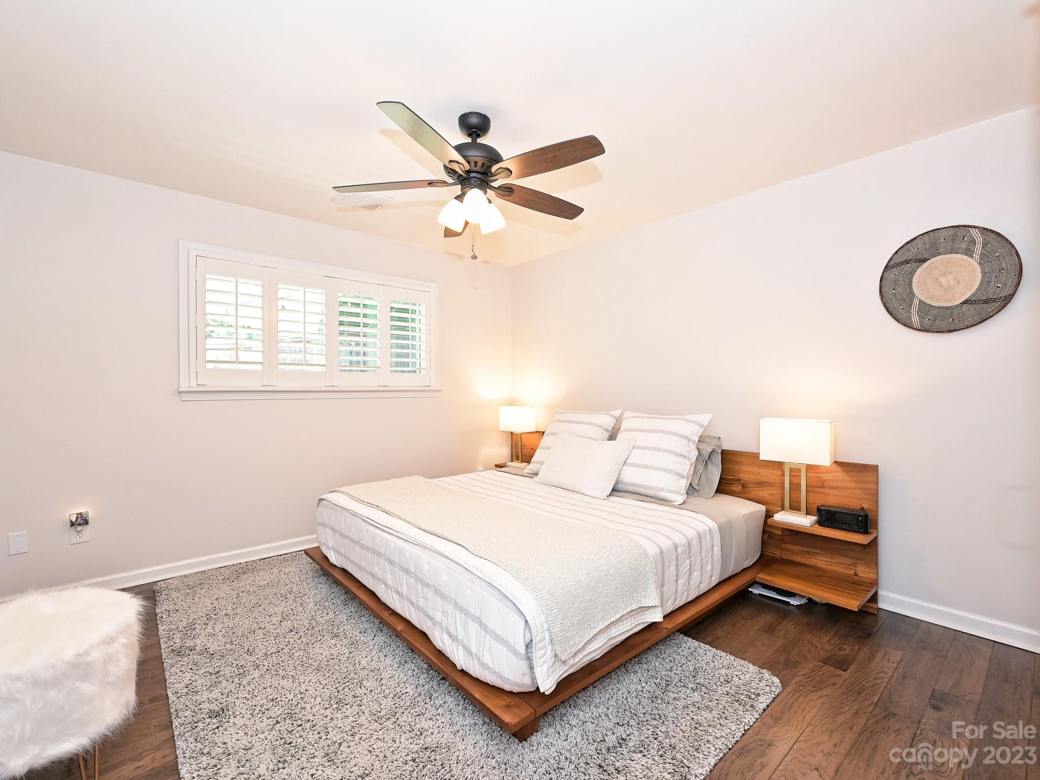 101 Scofield Road Charlotte, NC 28209 - Photo 14 of 26 a bedroom with a bed and a chandelier