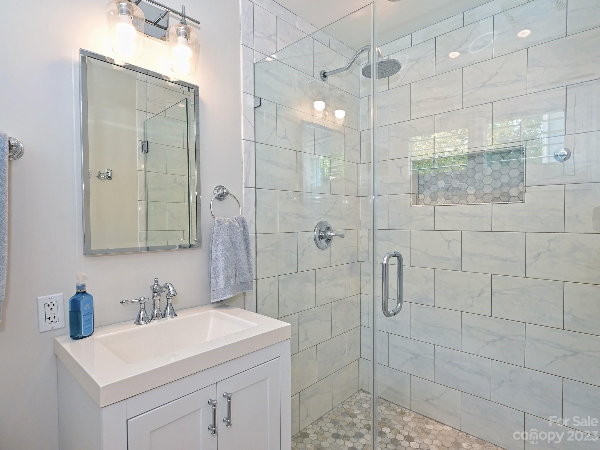 101 Scofield Road Charlotte, NC 28209 - Photo 16 of 26 a bathroom with a sink a toilet and shower