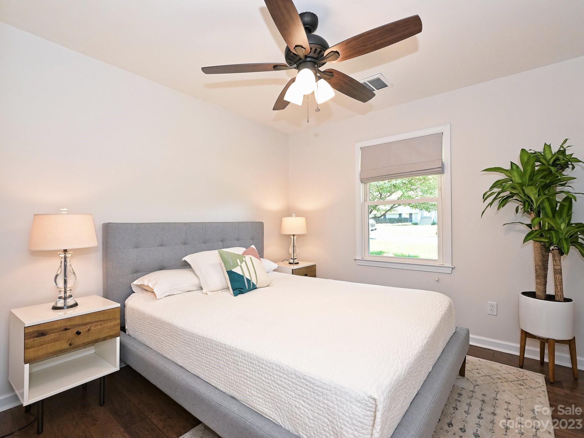 101 Scofield Road Charlotte, NC 28209 - Photo 17 of 26 a bedroom with a large bed and a chandelier