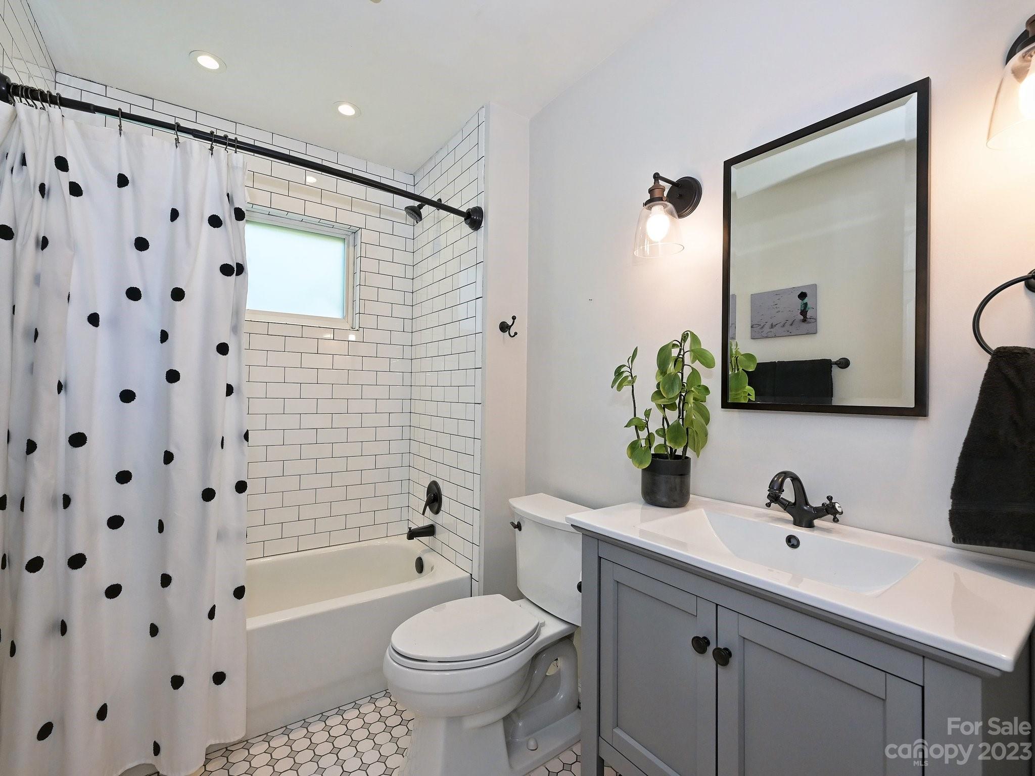 101 Scofield Road Charlotte, NC 28209 - Photo 19 of 26 a bathroom with a sink toilet a mirror a vanity and shower