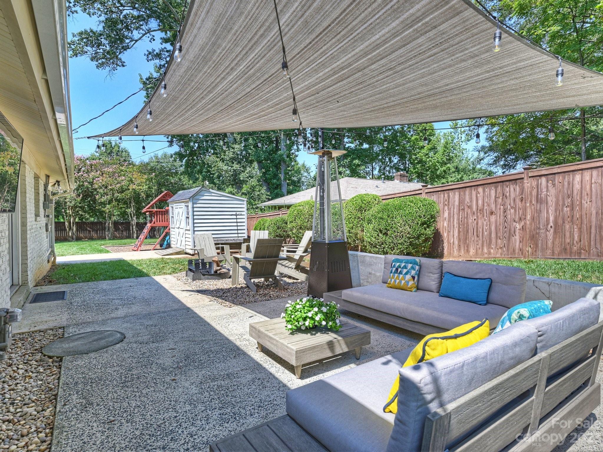 101 Scofield Road Charlotte, NC 28209 - Photo 22 of 26 a view of a patio with couches chairs under an umbrella