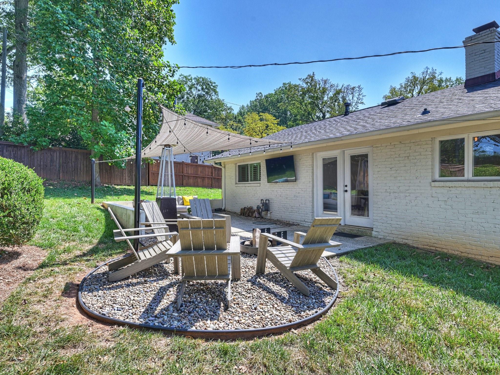 101 Scofield Road Charlotte, NC 28209 - Photo 23 of 26 a view of a house with backyard sitting area and garden