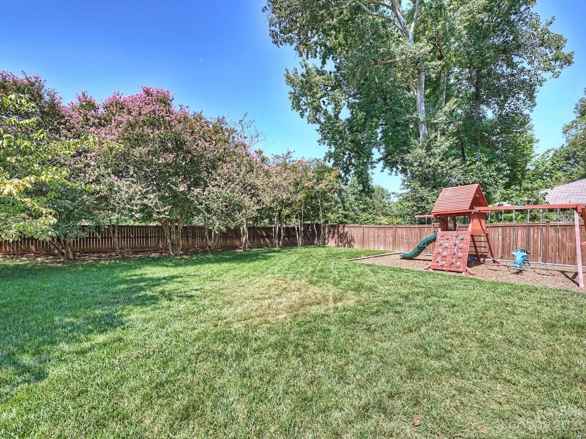 101 Scofield Road Charlotte, NC 28209 - Photo 25 of 26 a backyard of a house with seating and trees
