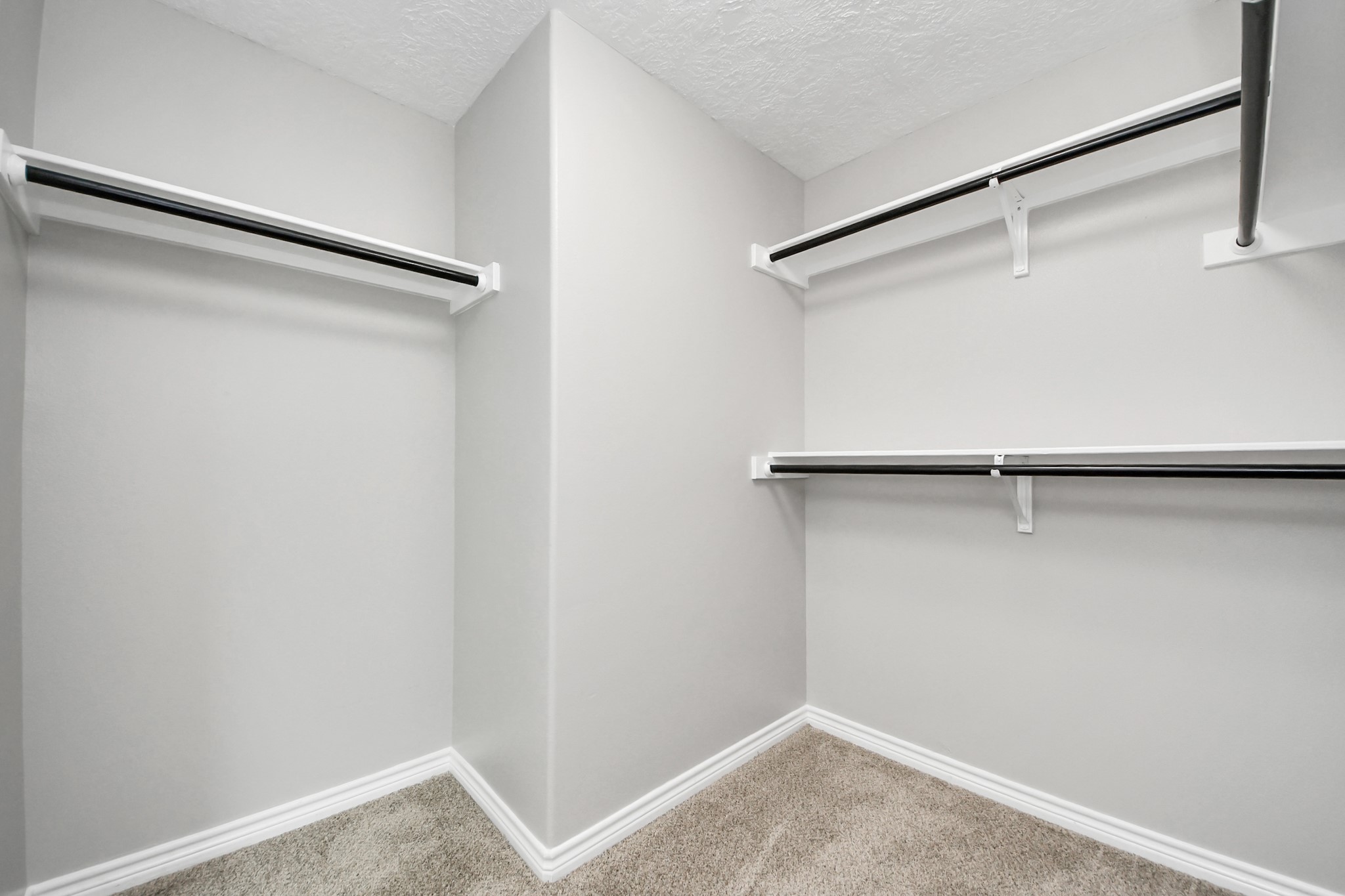 1105 East Kyle Road Clute, TX 77531 - Photo 29 of 44 The spacious walk-in closet just off the primary bathroom has multiple hanging rods, deal for organizing clothing and accessories.