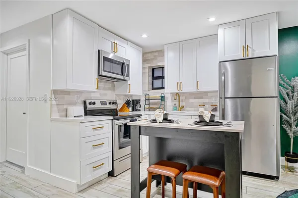 a kitchen with stainless steel appliances a refrigerator stove microwave and cabinets
