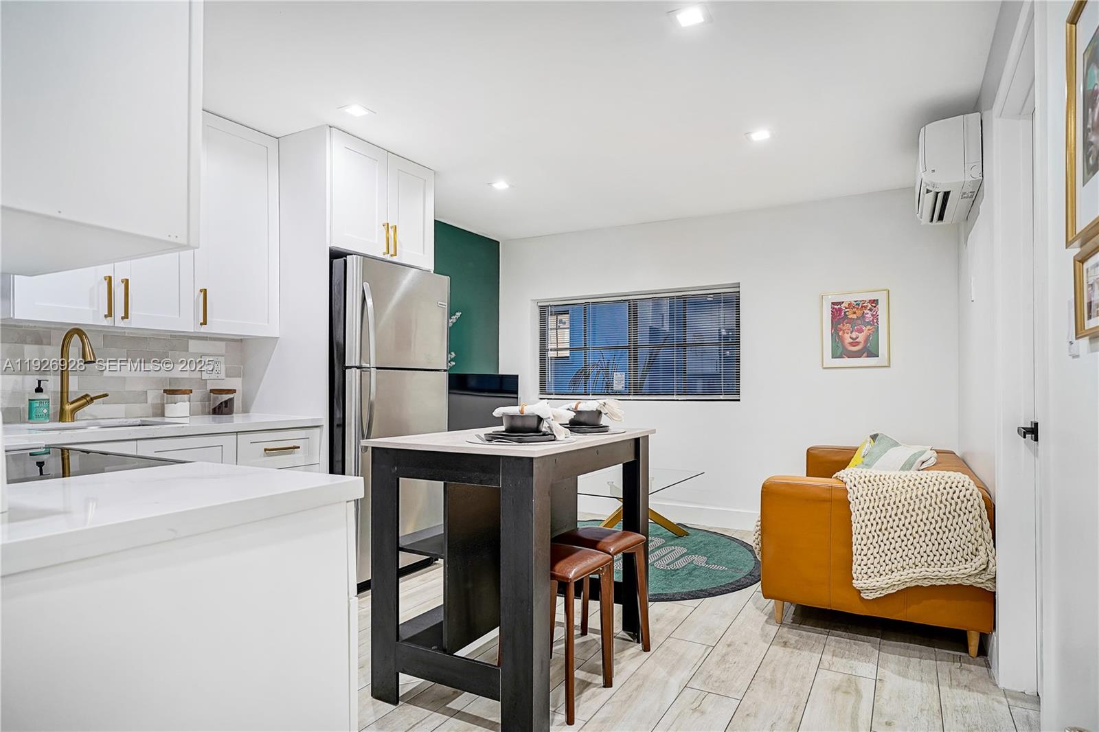 1720 Southwest 11th Street, Unit 2 Miami, FL 33135 - Photo 2 of 8 a kitchen with stainless steel appliances granite countertop a refrigerator and a stove