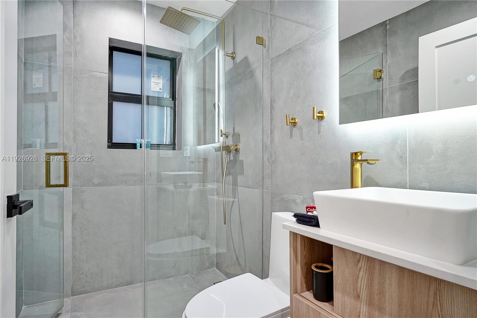 1720 Southwest 11th Street, Unit 2 Miami, FL 33135 - Photo 6 of 8 a bathroom with a sink a toilet and shower