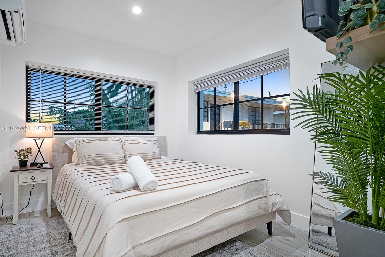 1720 Southwest 11th Street, Unit 2 Miami, FL 33135 - Photo 7 of 8 a bedroom with a large bed and a potted plant