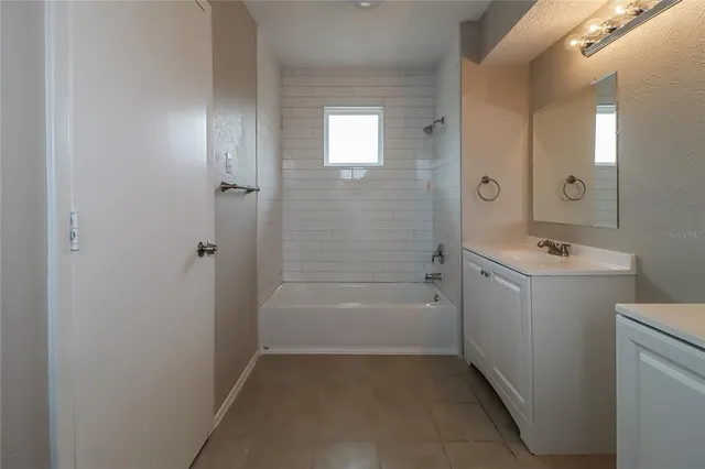 a bathroom with a granite countertop sink a toilet and shower