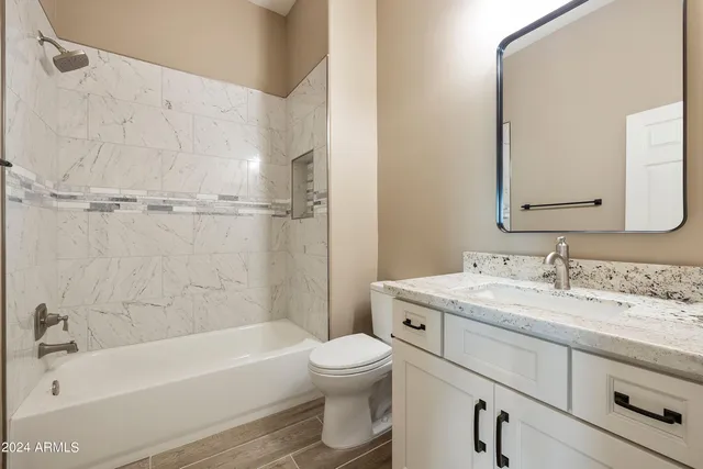 a view of an empty room with closet and bathroom