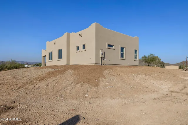 a kitchen with stainless steel appliances granite countertop a stove a sink and white cabinets with wooden floor
