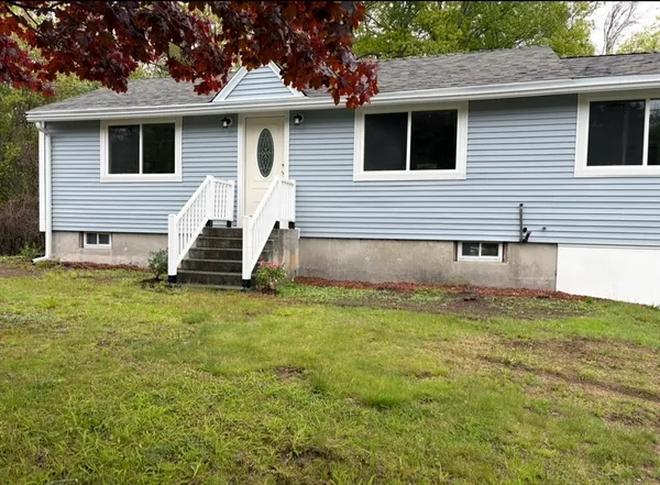 a view of a house with a yard