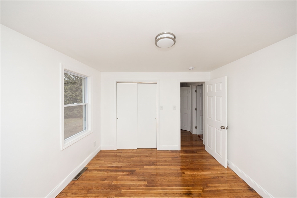 155 Southbridge Road Oxford, MA 01537 - Photo 16 of 42 a view of an empty room with wooden floor and a window