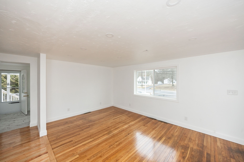 155 Southbridge Road Oxford, MA 01537 - Photo 29 of 42 an empty room with wooden floor and windows