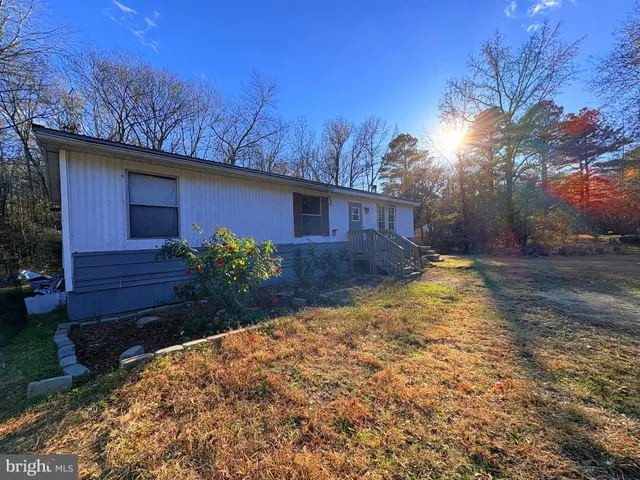 a view of a house with a yard and wooden fence