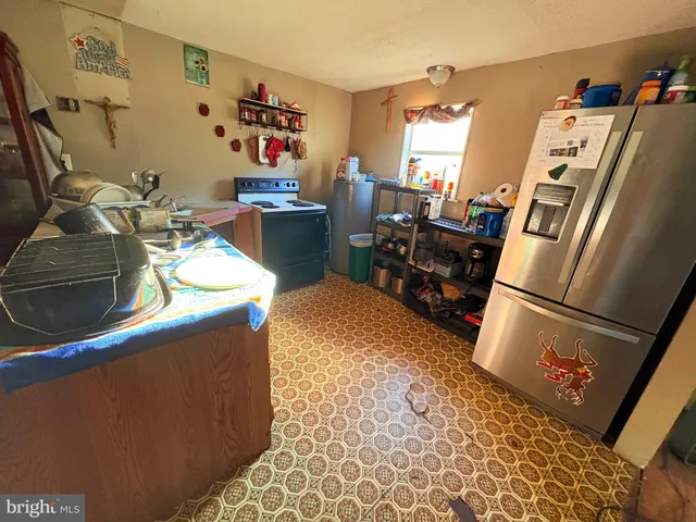 a living room with furniture and a ceiling fan