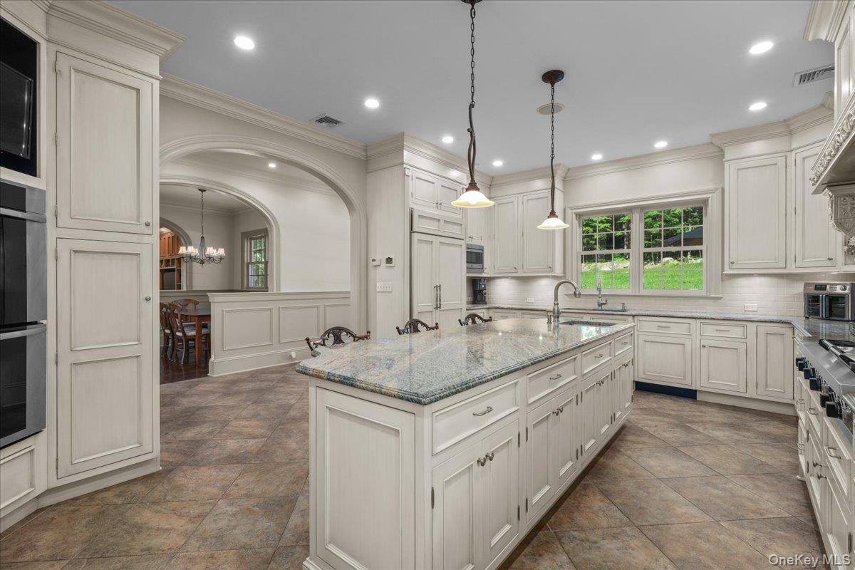 135 Pines Bridge Road Katonah, NY 10536 - Photo 5 of 40 a large white kitchen with a large window