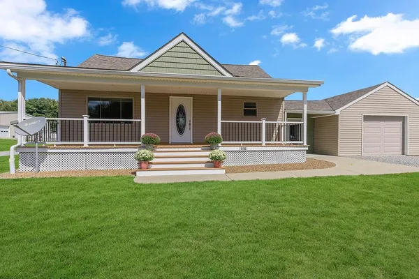 a front view of a house with a garden